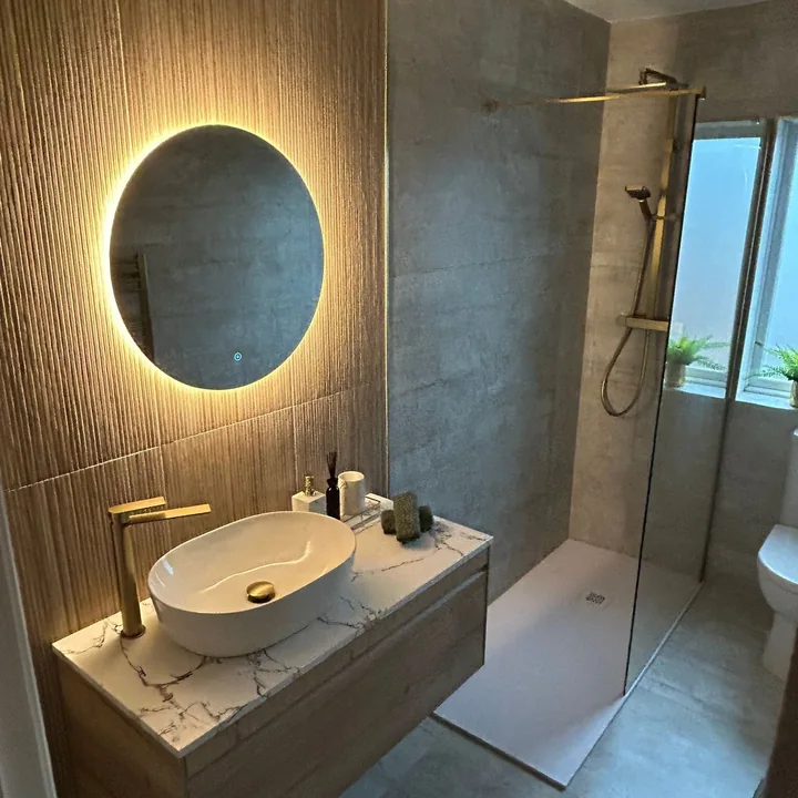 Modern grey bathroom renovation with illuminated round mirror by All Star Bathrooms Dublin