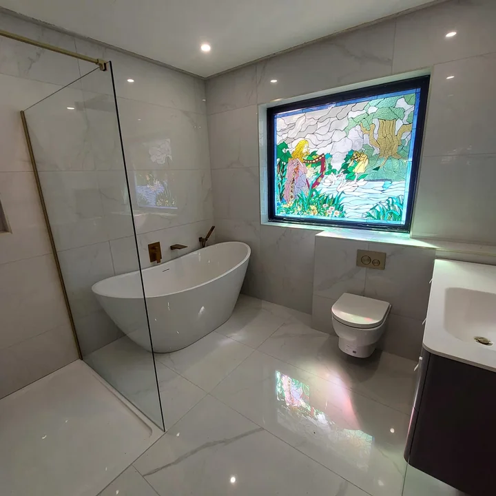 Bright bathroom renovation with freestanding bath and shower screen