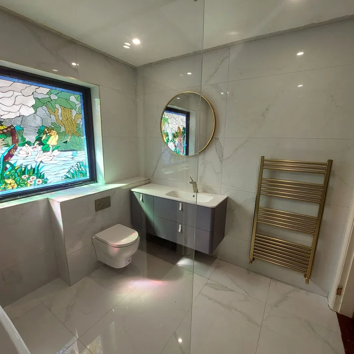 Bathroom refurbishment with vanity, heated towel rail and tiled finishes