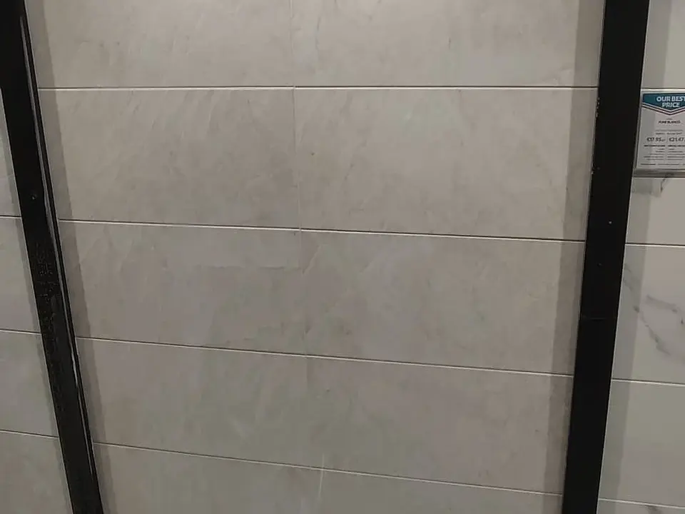 Large-format bathroom wall tiling installation