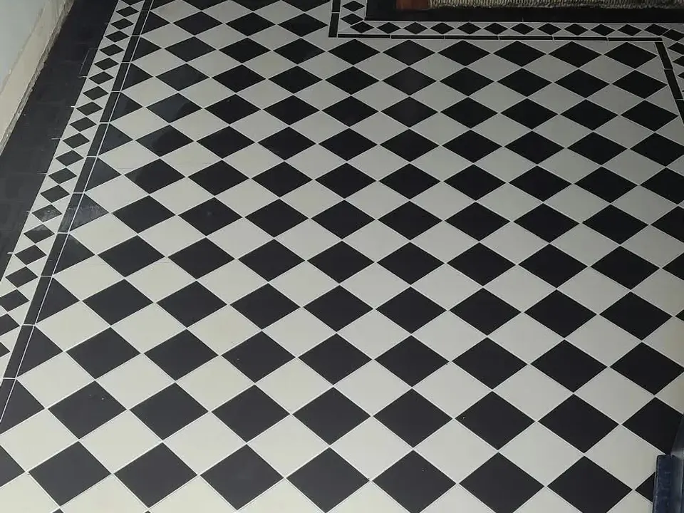 Completed black and white geometric tiled floor