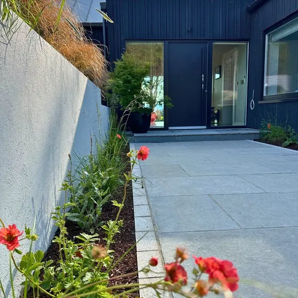 Completed paved courtyard beside a modern home