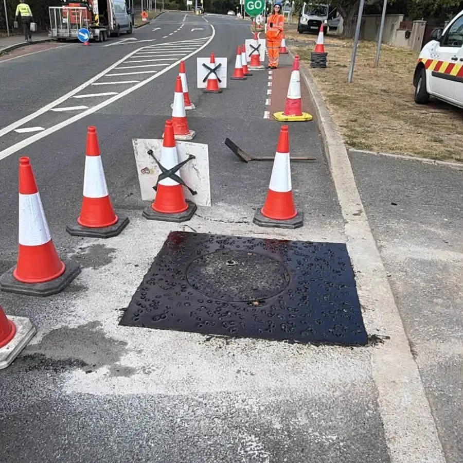 Completed asphalt road repair with traffic management