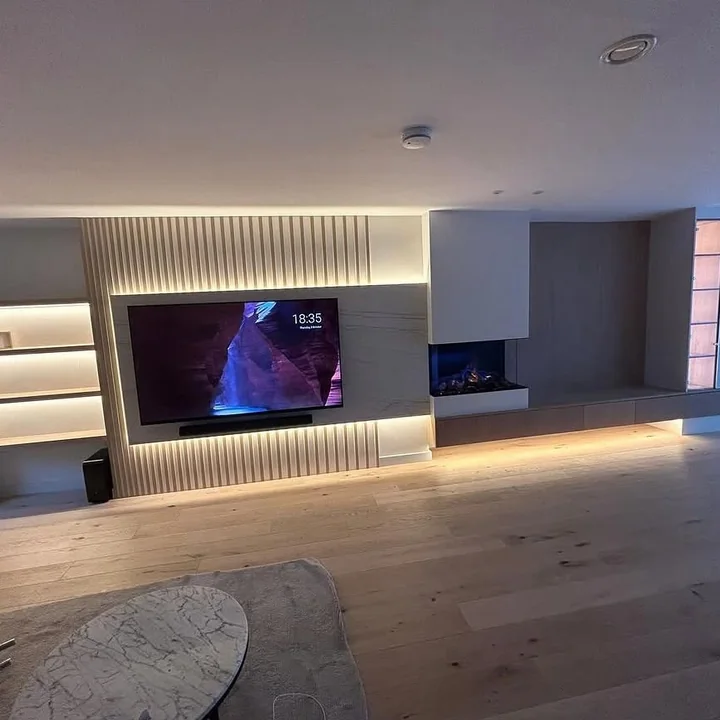Living room media wall with integrated feature lighting shown in the CO Electrical project gallery