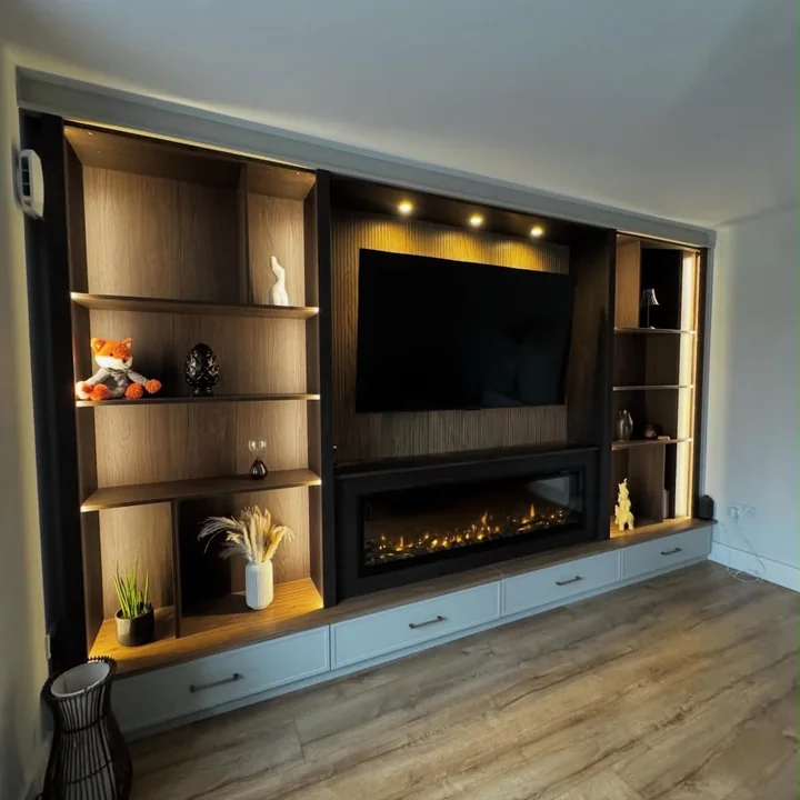 Media wall and shelving with integrated spot lighting shown in the CO Electrical project gallery