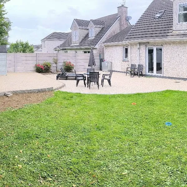 Completed resin paving around a lawn and patio