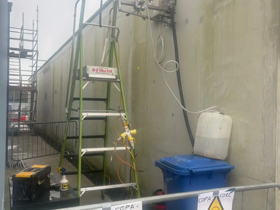COPA core drilling equipment set up on an external wall