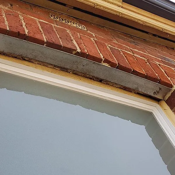 Brick arch and lintel work above a window