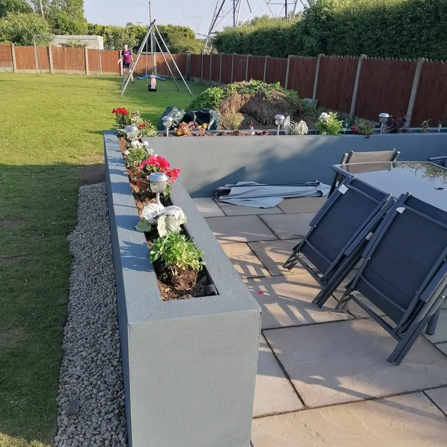 Raised patio with paving, planting and garden seating