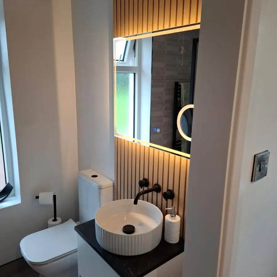 Finished bathroom vanity, tiling and illuminated mirror