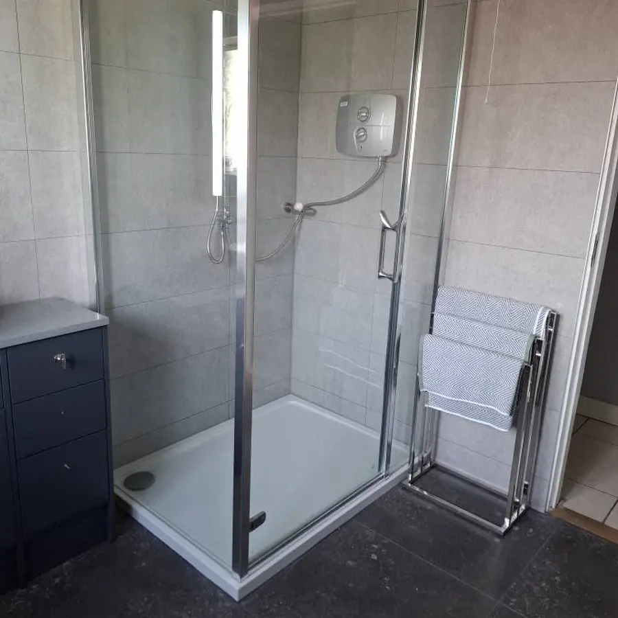 Completed shower-room renovation with glass enclosure