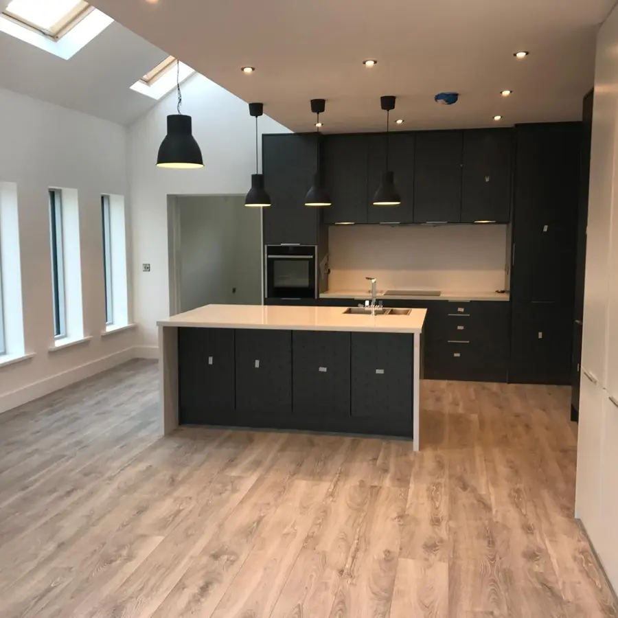 Completed dark fitted kitchen and open-plan living area