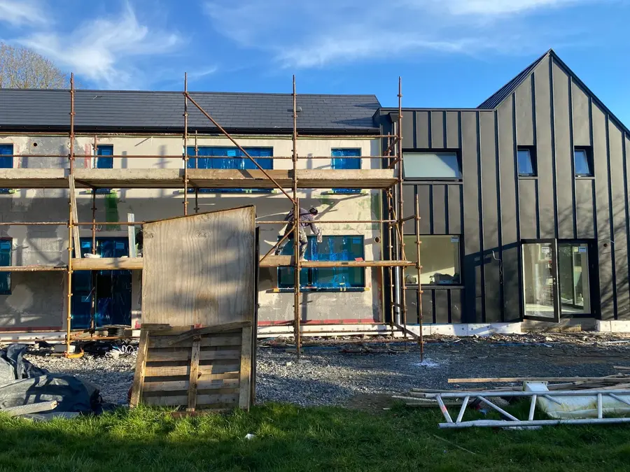 Exterior building project beside a dark-clad gable