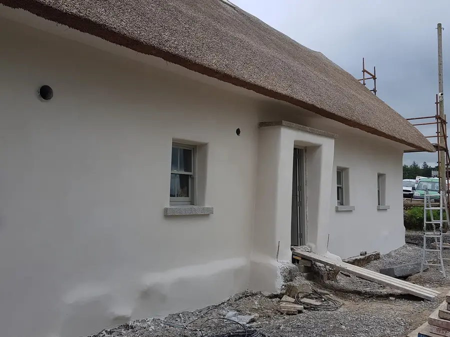 Completed white rendered exterior by Iacob Plastering & Building Ltd