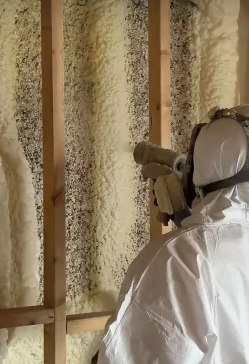 Insulation installer applying spray foam to a wall — Innovate Insulation