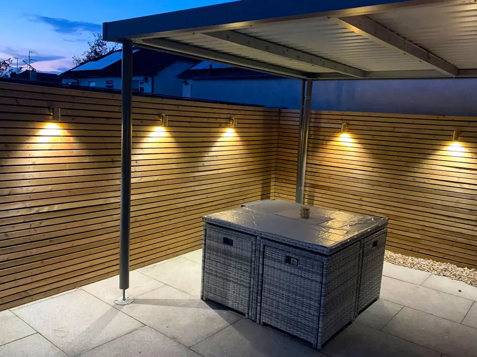 JK Electrical canopy lighting installation over a Dublin patio at dusk