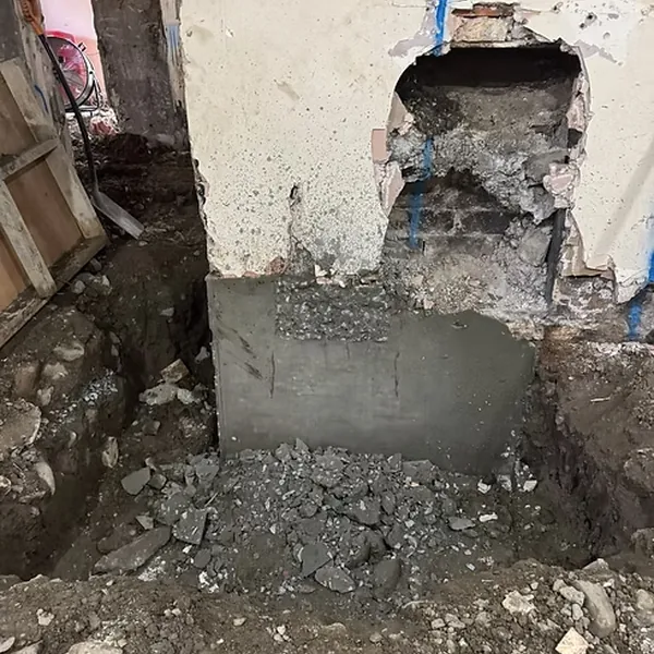 Underpinning and foundation repair beside an existing structure