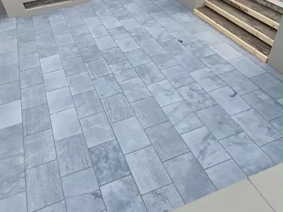 Completed grey tiled patio and outdoor steps