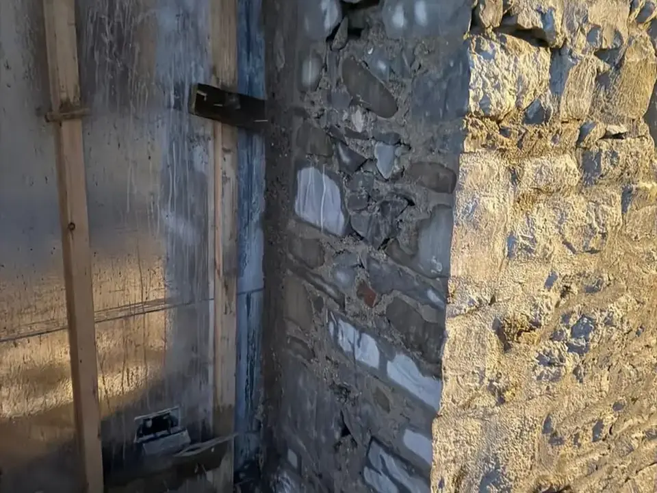 Controlled vertical opening cut through a stone wall