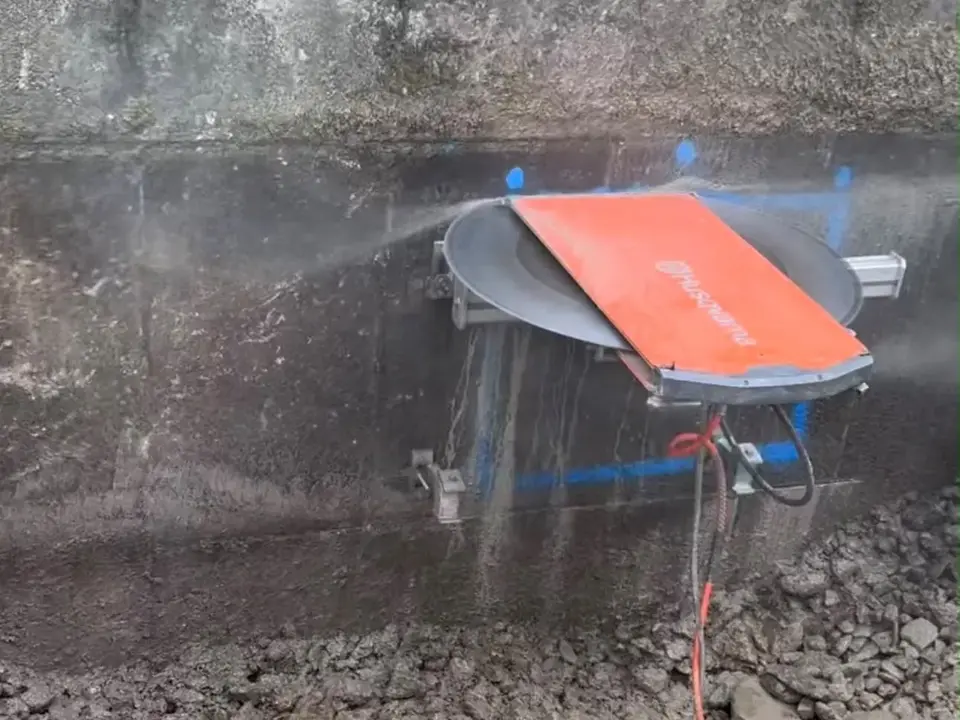 Wall saw cutting a controlled opening through concrete
