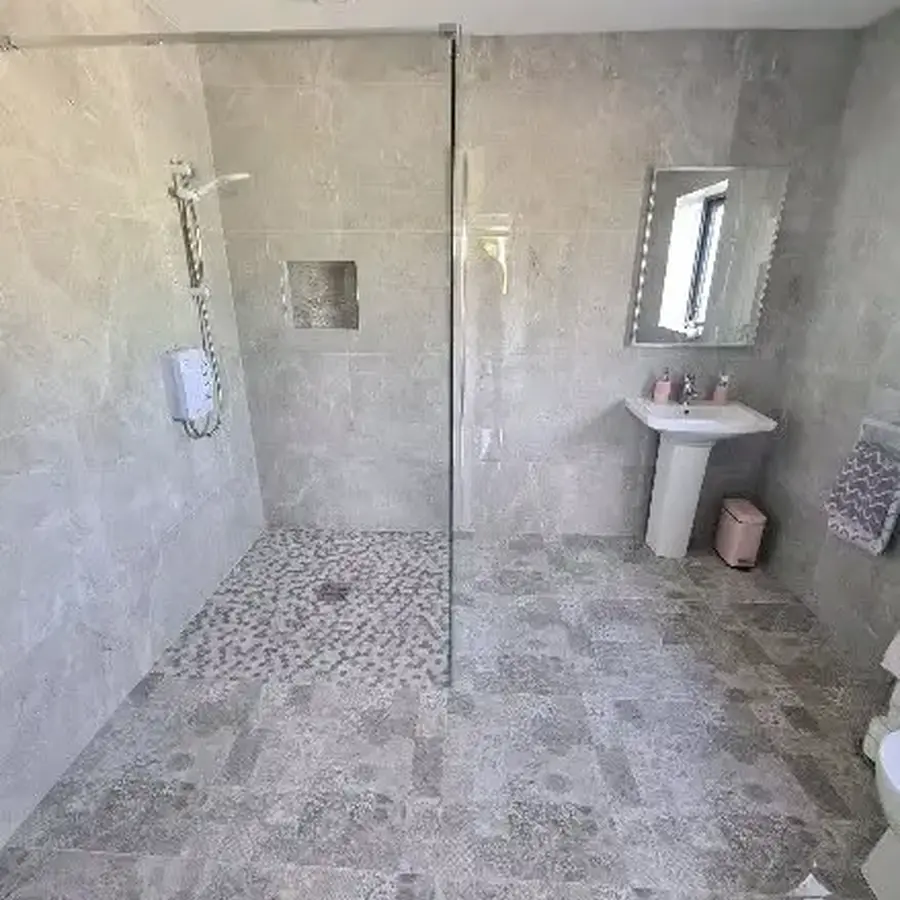 Walk-in shower with floor and wall tiling