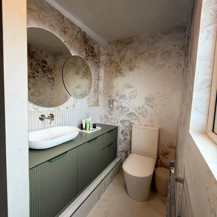 Complete bathroom fitout with vanity, toilet and decorative wall tiling by PrimeLine Plumbing Solutions