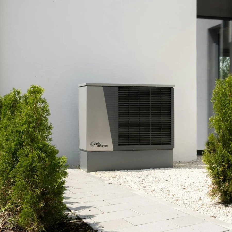 Outdoor heat-pump unit beside a modern home
