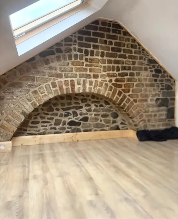 Attic brick feature wall after cleaning and repointing by Rigney Restoration
