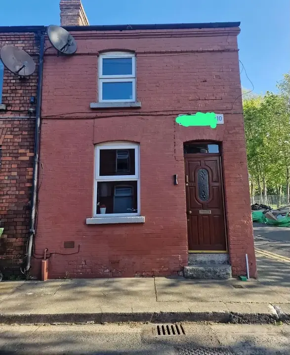 Painted brick Dublin house façade before paint removal and restoration