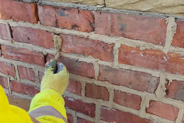 Repointing weathered brickwork with fresh mortar