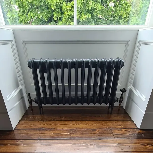 Installed black radiator in a finished interior