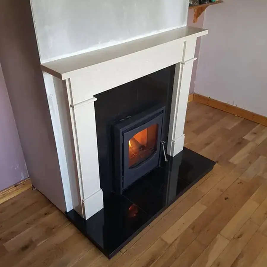 Installed stove and fireplace surround